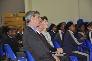 Senior Director of International Alumni Eric DeHaan, IU President Michael McRobbie, IU First Lady Laurie McRobbie watch students perform at Christel House South Africa.