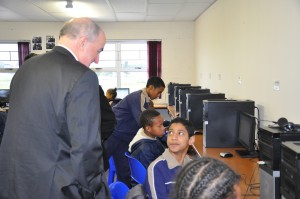 IU President Michael McRobbie talks computers with a Christel House South Africa student.