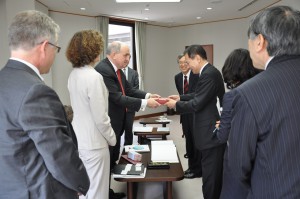 IU President Michael A. McRobbie, left, presents Waseda University President Kaoru Kamata with a gift.
