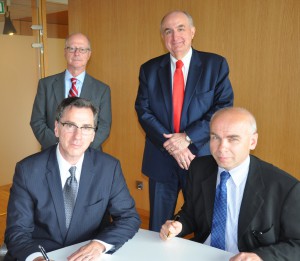 L-R in front: IU School of Global and International Studies Dean Lee Feinstein and Dariusz Stola, director of the POLIN Museum of the History of Polish Jews, sign an internship agreement between IU and the museum. IU Vice President for International Affairs David Zaret and President McRobbie are standing in back.