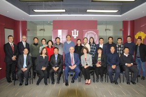 IU President McRobbie and members of the delegation pose for a picture with participants at the Ostrom Symposium at the IU China Gateway office. 