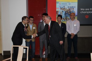 IU President McRobbie congratulates members of a victorious basketball team made up of IU Chinese alumni.